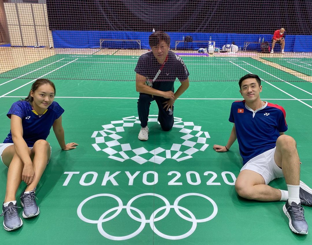 鄧俊文、謝影雪與教練在奧運比賽場地合照。