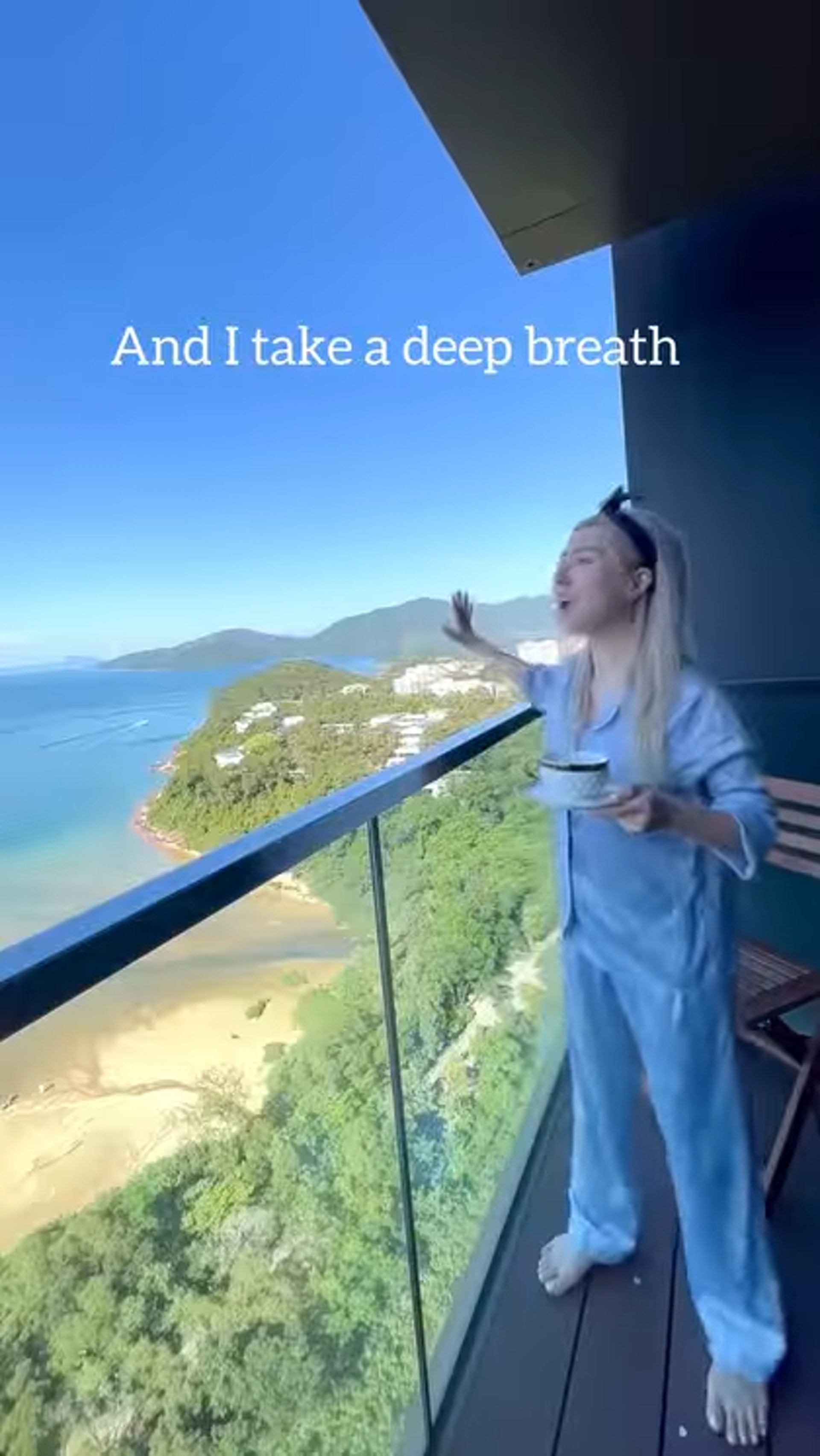 譚嘉儀剛起床身穿睡衣赤著腳,並走出露台扮唱歌。