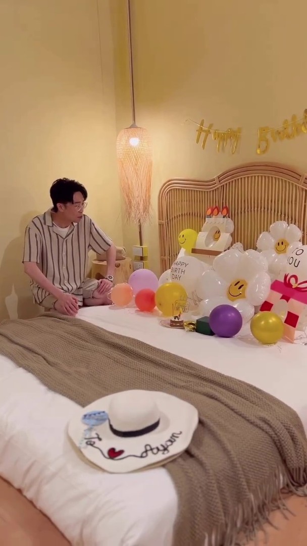 床上有氣球及生日蛋糕仔。