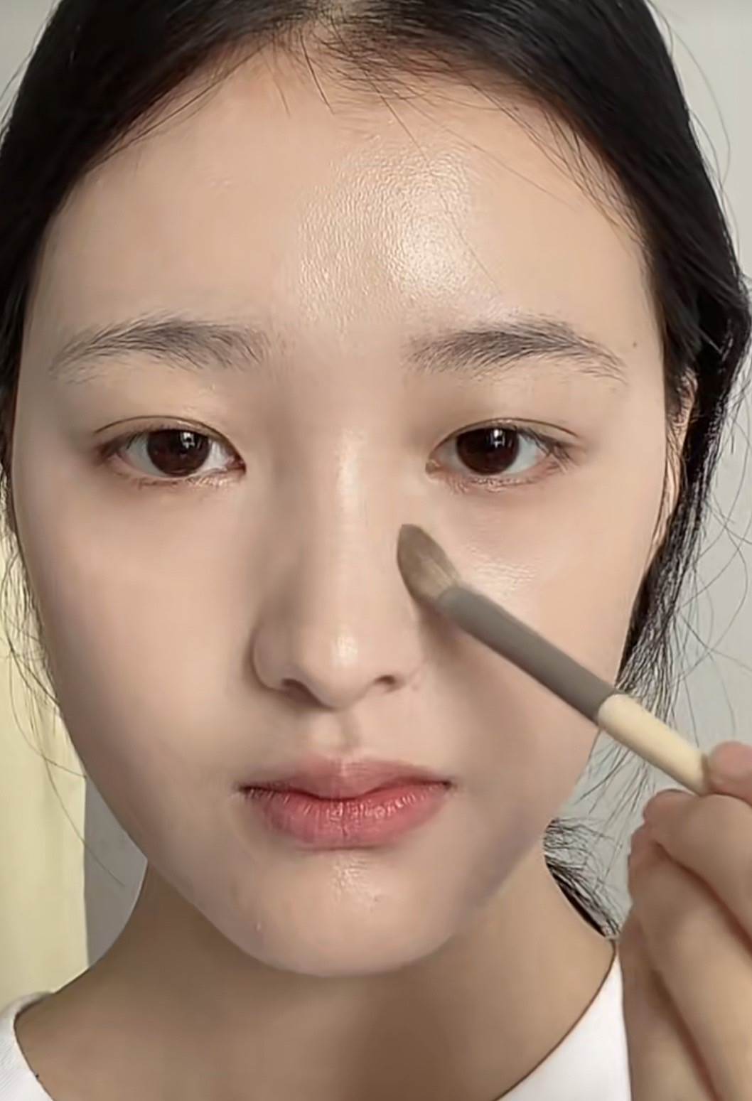 用筆刷沾取蜜粉,針對鼻托會覆蓋的區域。