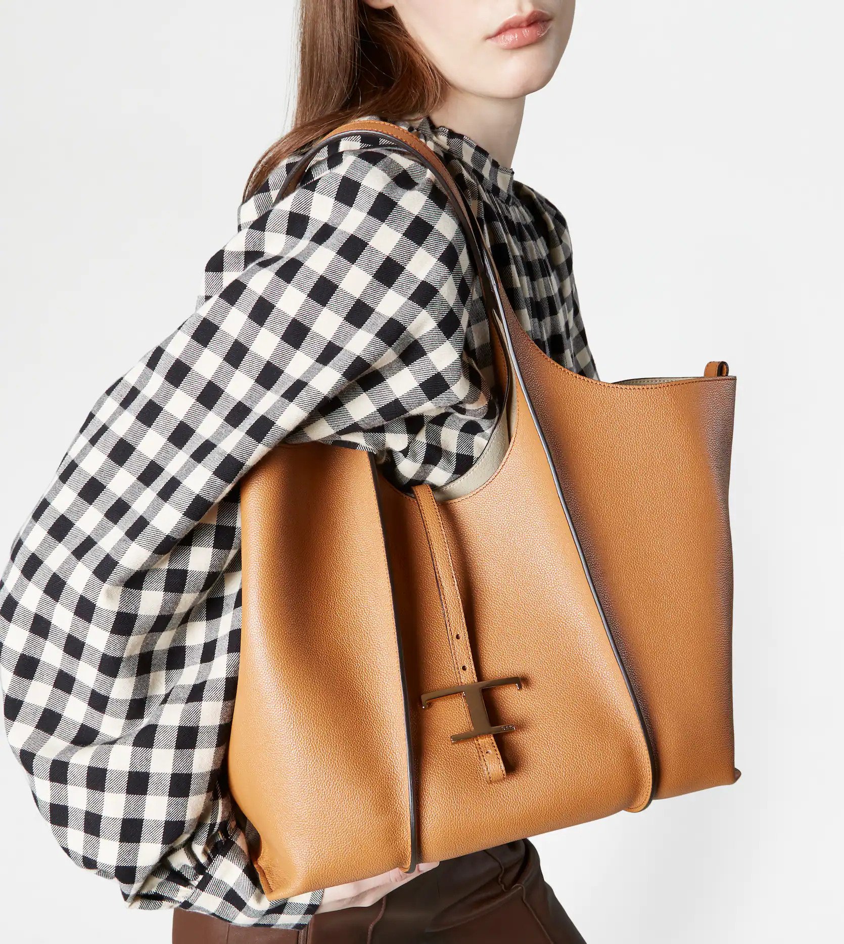 結合品牌字母的「T」字吊飾是袋款經典象徵。